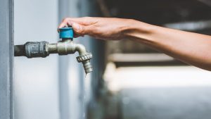 Dona chiude un rubinetto dell'acqua